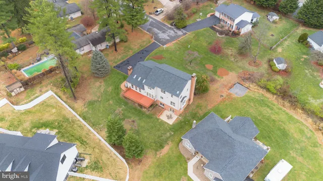 a view of a house with a big yard and large trees