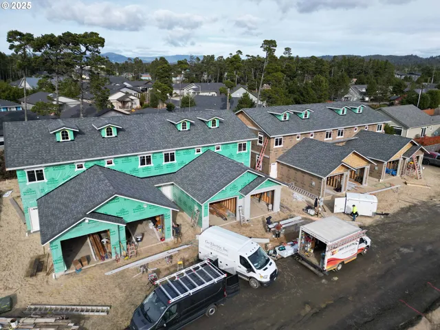 an aerial view of a houses with city view