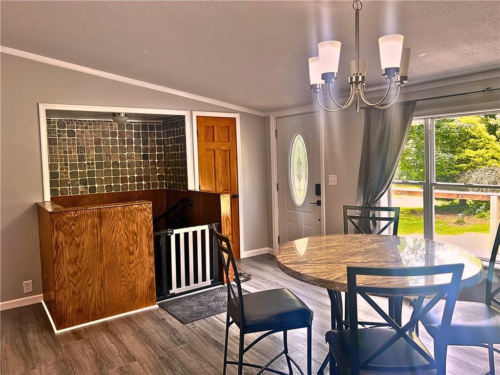 1155 Union Flat Road Shelocta, PA 15774 - Photo 5 of 38 a view of a dining room with furniture a chandelier and wooden floor