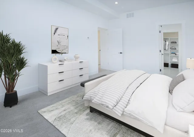 a bed room with a bed and a potted plant