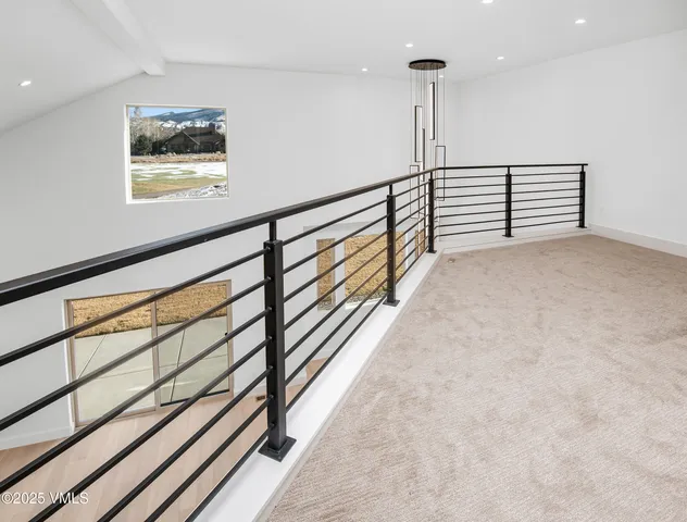 a view of staircase with wooden floor and a window