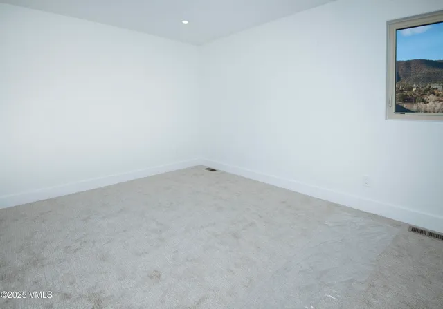 a bed sitting in a bedroom and painting on the wall