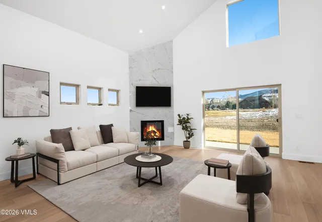 a living room with furniture a fireplace and a flat screen tv