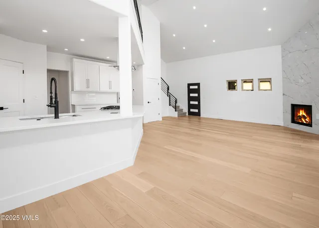 a view of kitchen with kitchen island microwave and cabinets