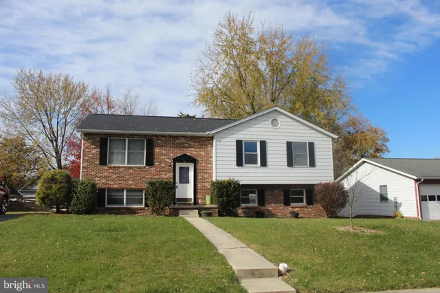 a front view of a house with a garden and yard