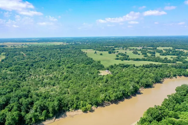 an aerial view of a city with lots of residential buildings and mountain view in back