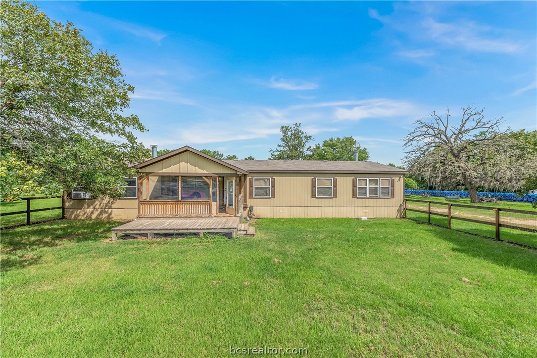 6909 Zak Road Bryan, TX 77808 - Photo 1 of 1 a front view of a house with a yard