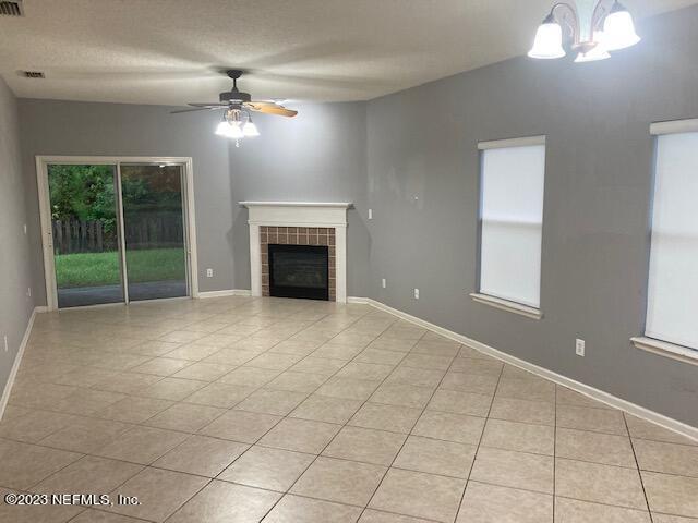 321 Stonehurst Parkway St. Augustine, FL 32092 - Photo 12 of 39 a view of an empty room with a fireplace and a window