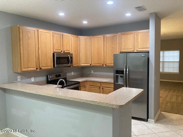 321 Stonehurst Parkway St. Augustine, FL 32092 - Photo 8 of 39 a kitchen with stainless steel appliances granite countertop a sink a microwave a refrigerator and grey cabinets