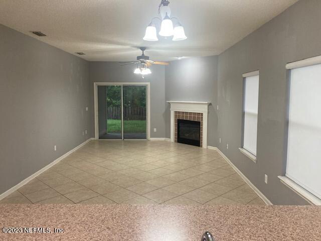 321 Stonehurst Parkway St. Augustine, FL 32092 - Photo 9 of 39 a view of an empty room with a fireplace and a window