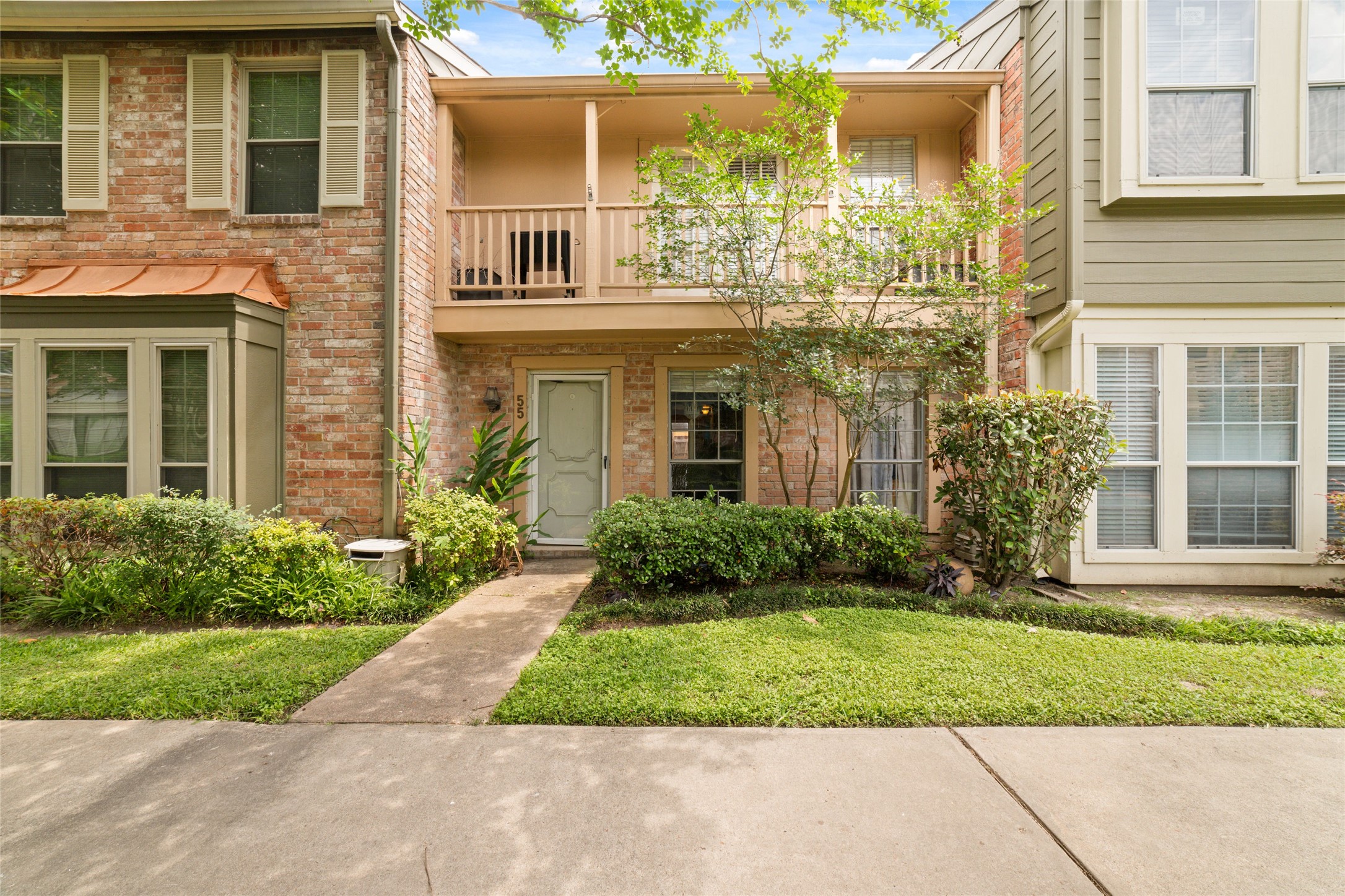 5800 Lumberdale Road, Unit 55 Houston, TX 77092 - Photo 1 of 34 a front view of a house with garden