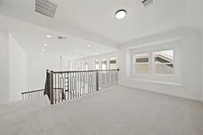 a view of staircase with wooden floor and a window