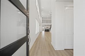 5423 Peach Gdn Way Manvel, TX 77578 - Photo 2 of 20 Bright, modern entryway with high ceilings and wood flooring leading to an open living area. Abundant natural light from large windows enhances the spacious feel.