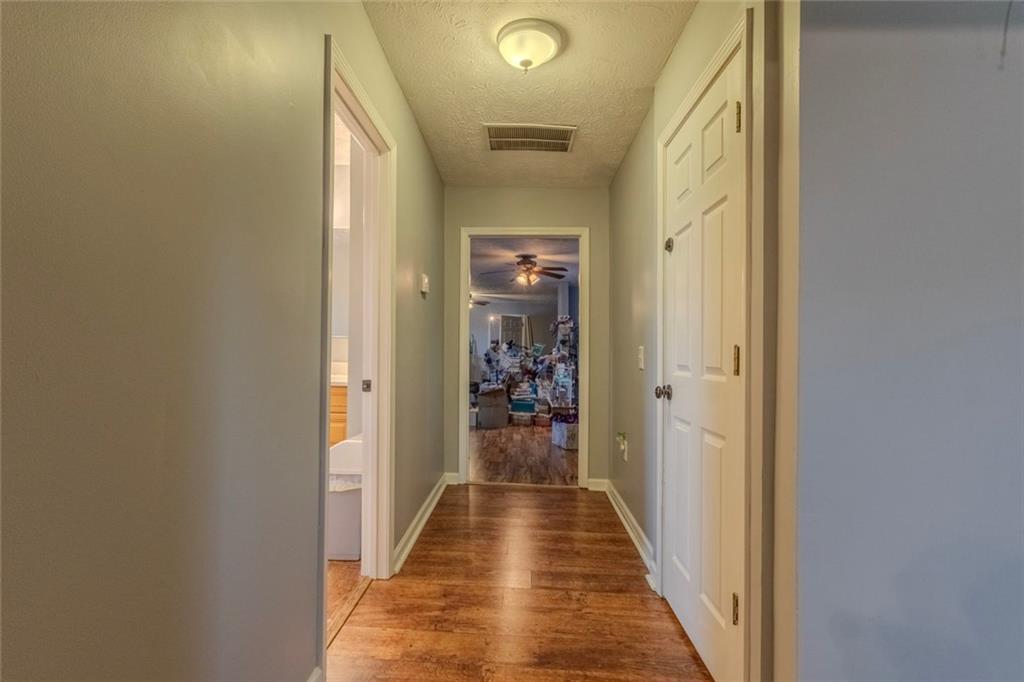 160 Highway 320 Carnesville, GA 30521 - Photo 28 of 68 a view of a hallway with wooden floor and a bathroom