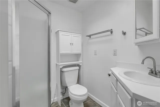a bathroom with a sink toilet and a mirror