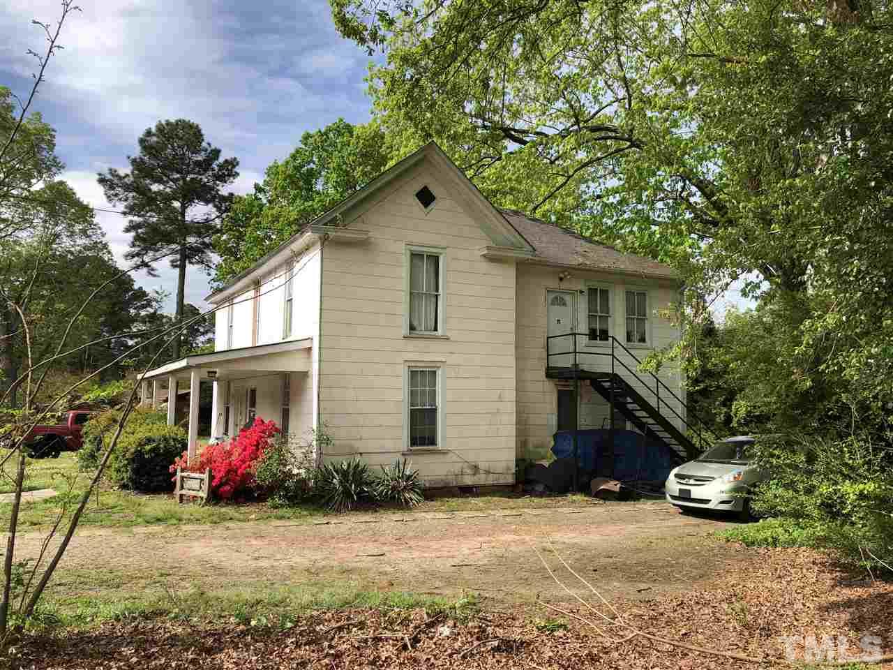 208 Jones Franklin Road Raleigh, NC 27606 - Photo 2 of 5 a front view of a house with a yard and garage