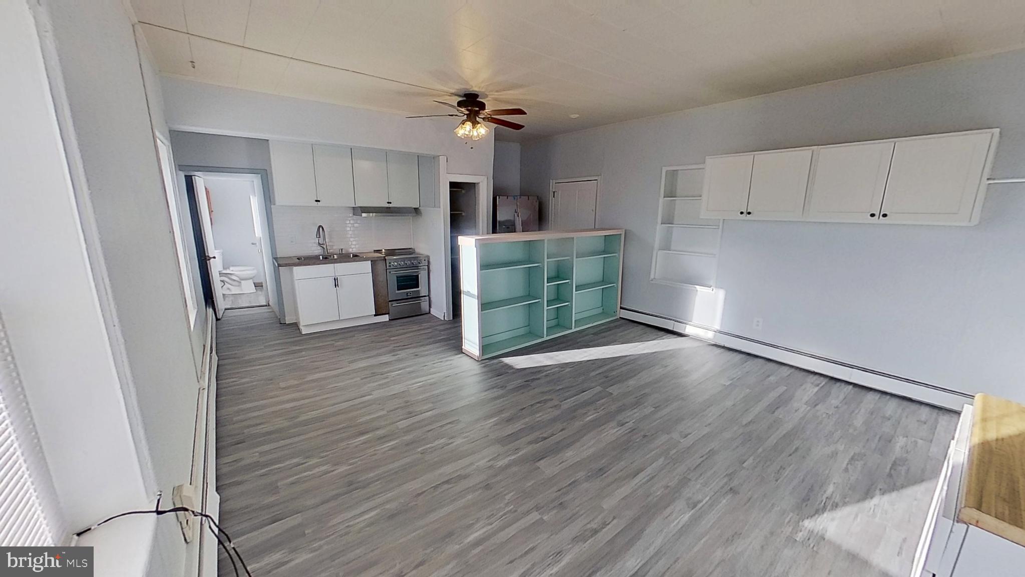 1 South Main Street Loganville, PA 17360 - Photo 2 of 5 a view of a kitchen with wooden floor and a sink