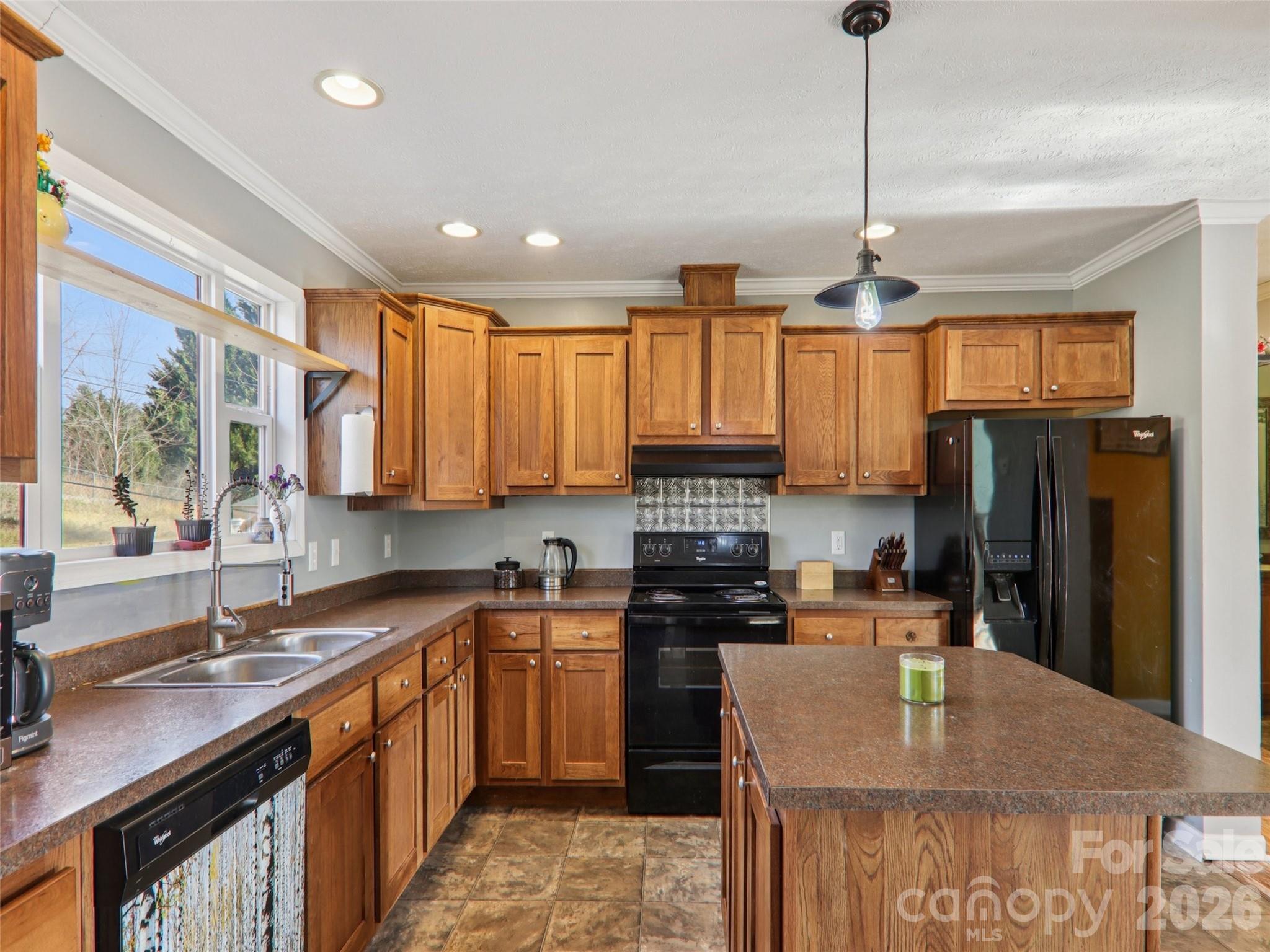 3195 North Clear Creek Road Hendersonville, NC 28792 - Photo 11 of 21 a kitchen with stainless steel appliances granite countertop a sink a stove and a refrigerator