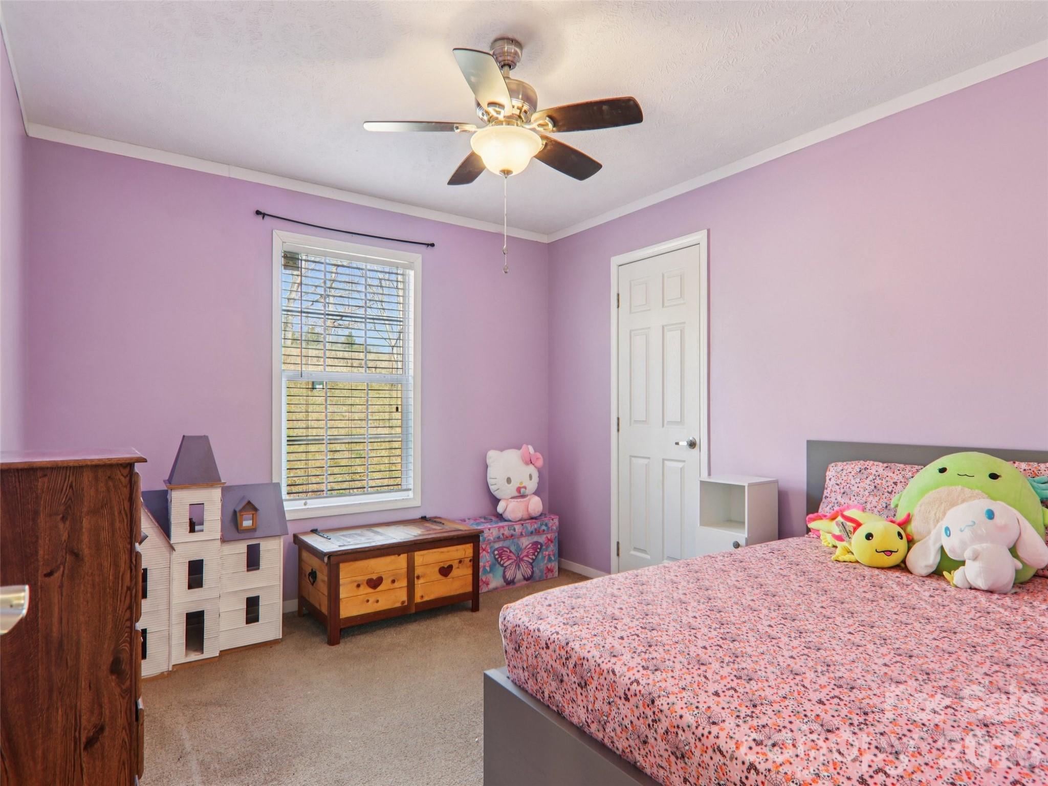 3195 North Clear Creek Road Hendersonville, NC 28792 - Photo 13 of 21 a bedroom with a bed and a chandelier