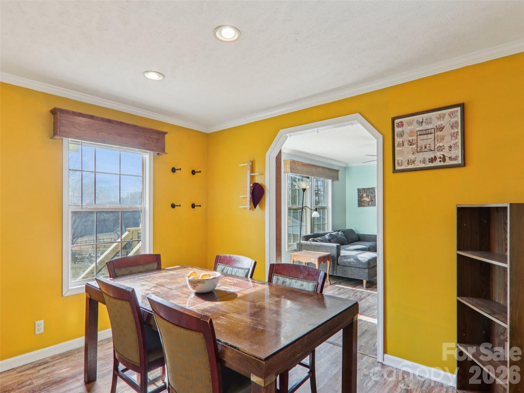 3195 North Clear Creek Road Hendersonville, NC 28792 - Photo 7 of 21 a view of a dining room with furniture and wooden floor