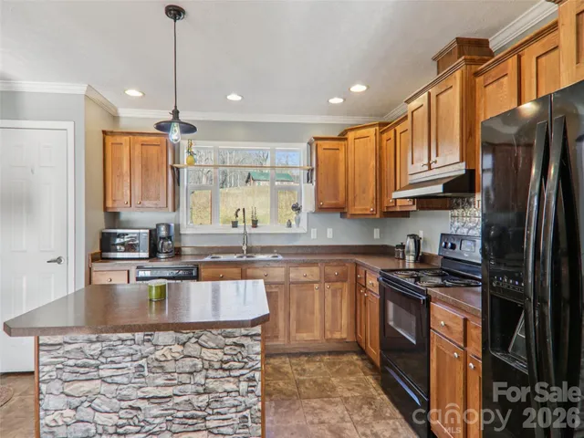 a kitchen with stainless steel appliances granite countertop a sink stove and refrigerator