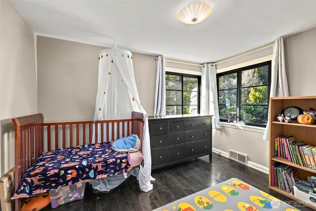 a bed room with a bed and a television