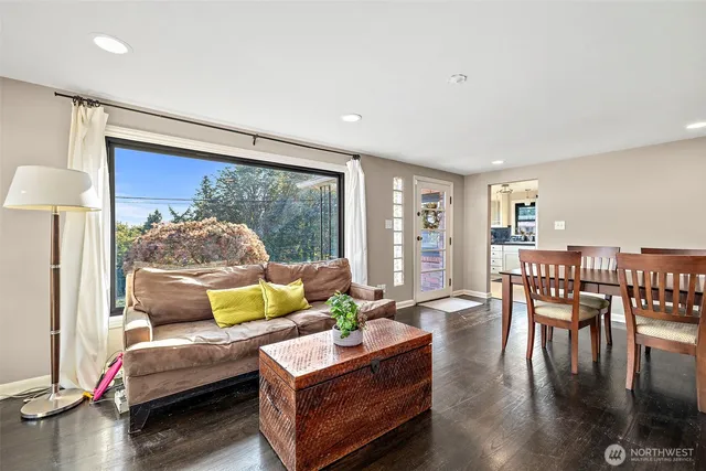 a living room with furniture fireplace and a table