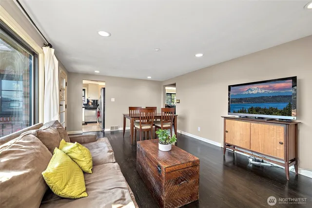 a view of a hallway with wooden floor and closet
