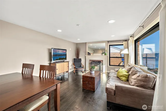a utility room with stainless steel appliances wooden floor and a window