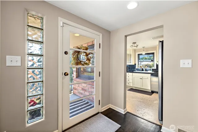 a kitchen with granite countertop a stove a sink and a wooden cabinets