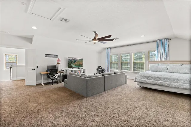 a living room with furniture and a ceiling fan