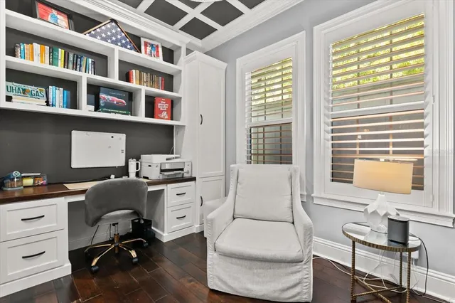 a view of a livingroom with wooden floor and furniture