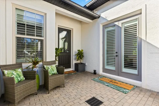 an aerial view of a house with a yard swimming pool and outdoor seating