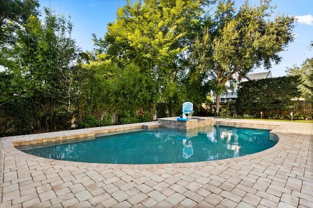 a kitchen with a sink a stove and a wooden floors