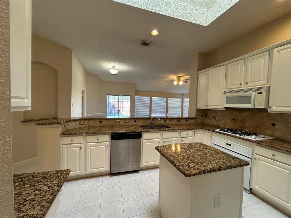 3805 Pine Valley Drive Plano, TX 75025 - Photo 5 of 16 a kitchen with a stove sink and cabinets