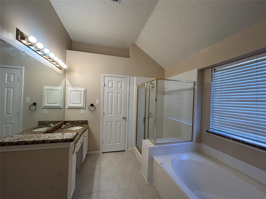3805 Pine Valley Drive Plano, TX 75025 - Photo 10 of 16 a spacious bathroom with a granite countertop sink and a mirror