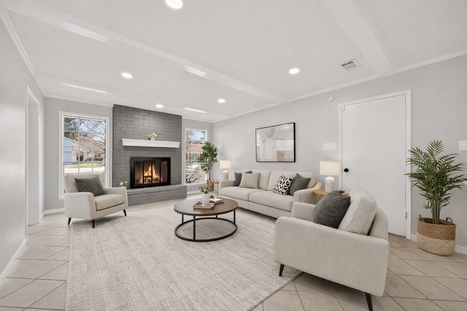Virtually staged living area showcasing spacious layout, fireplace, and natural light.