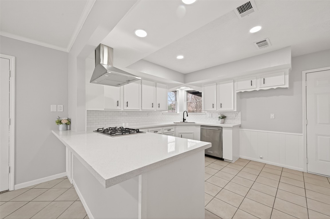 21710 Rotherham Drive Spring, TX 77388 - Photo 12 of 49 Bright, open kitchen featuring a large center island, crisp white cabinetry, and modern finishes