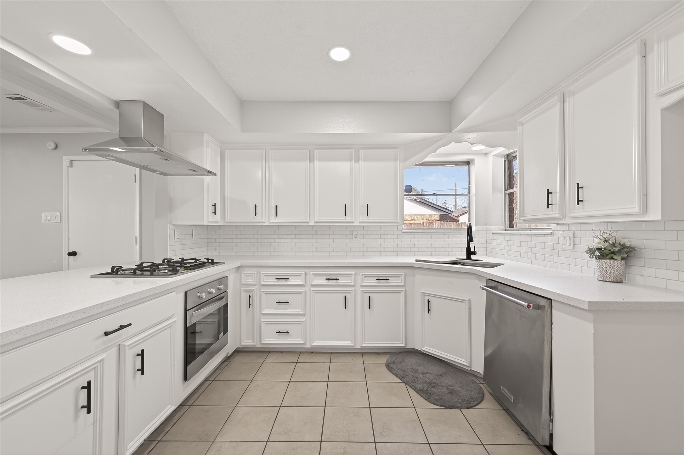 21710 Rotherham Drive Spring, TX 77388 - Photo 13 of 49 a kitchen with a stove sink and cabinets