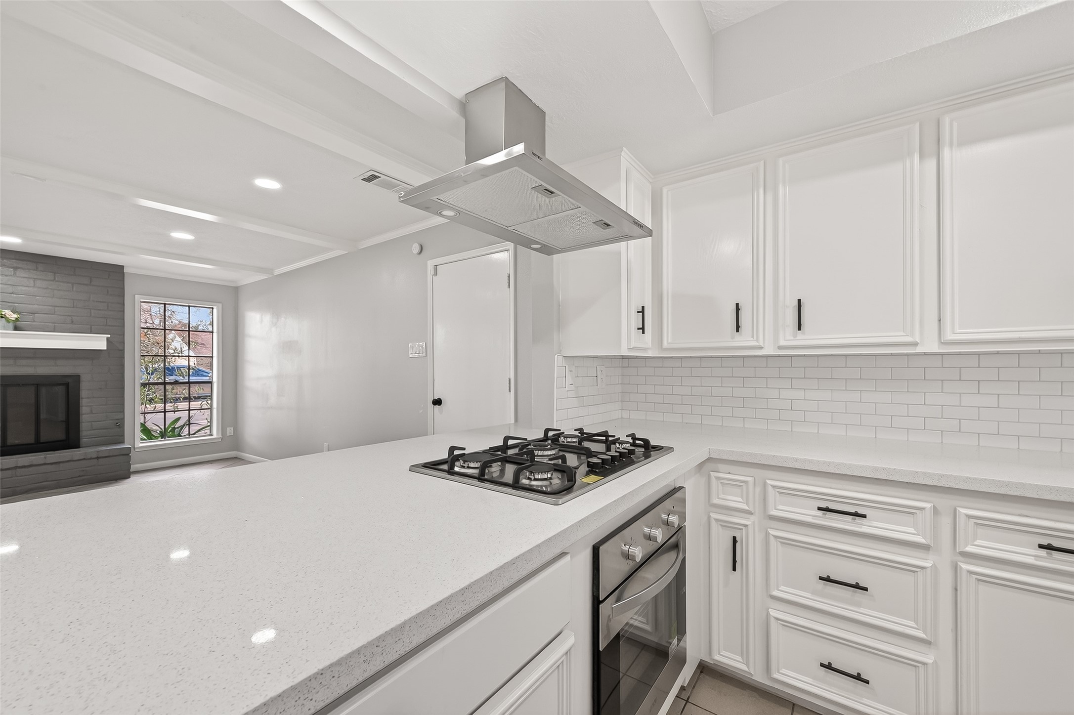 21710 Rotherham Drive Spring, TX 77388 - Photo 14 of 49 a kitchen with granite countertop a stove a sink dishwasher and white cabinets with wooden floor
