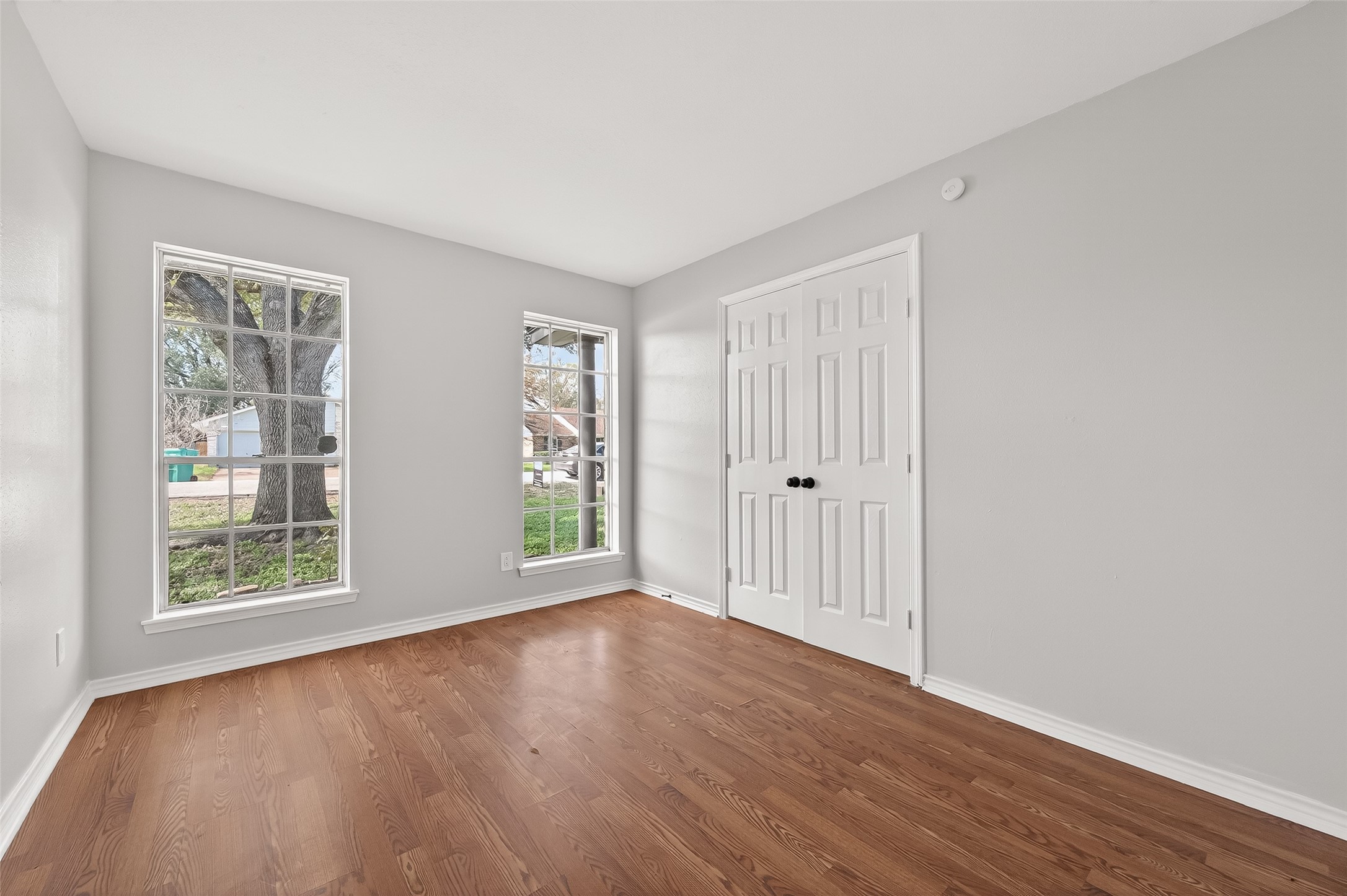 21710 Rotherham Drive Spring, TX 77388 - Photo 17 of 49 an empty room with wooden floor and windows
