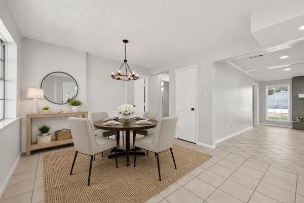 a view of a dining room with furniture and chandelier