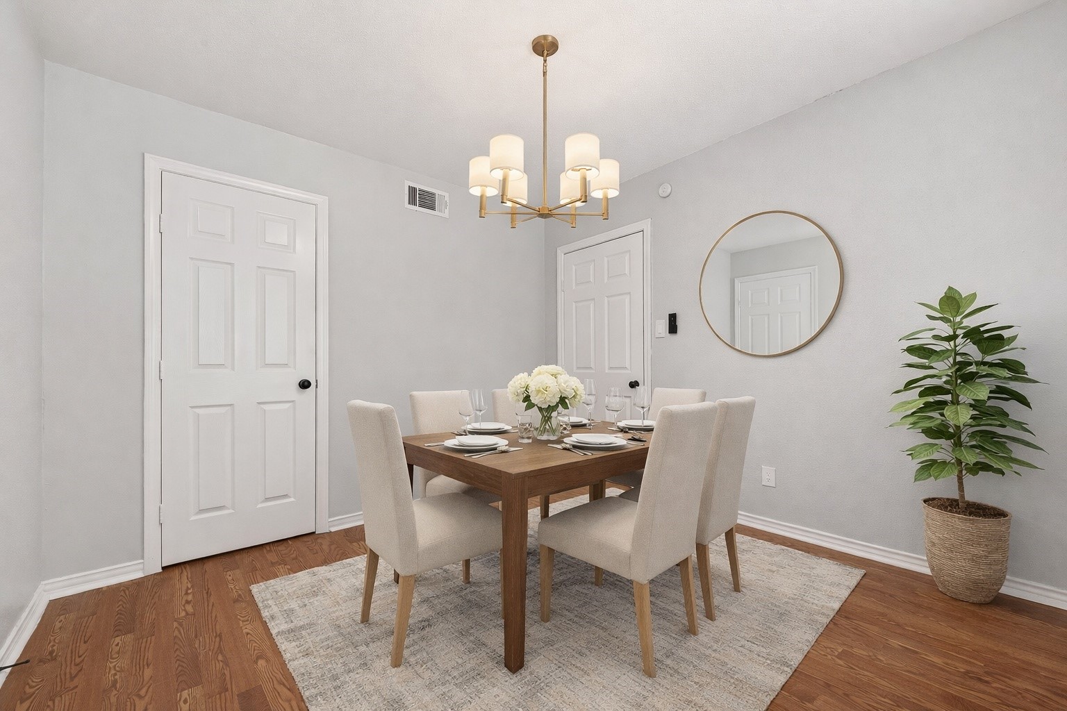 21710 Rotherham Drive Spring, TX 77388 - Photo 25 of 49 a dining room with furniture a chandelier and wooden floor
