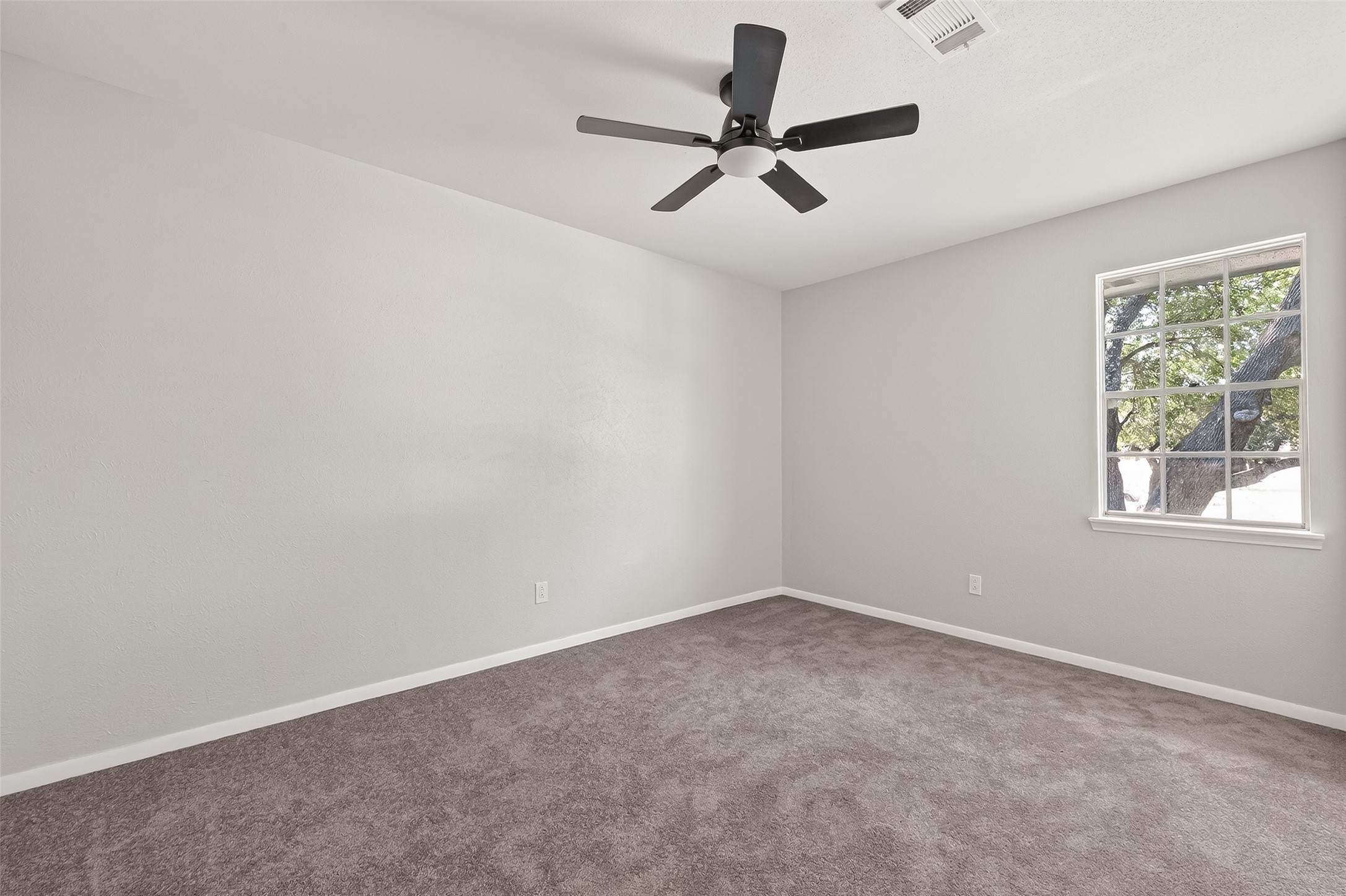 21710 Rotherham Drive Spring, TX 77388 - Photo 35 of 49 an empty room with a window and a fan