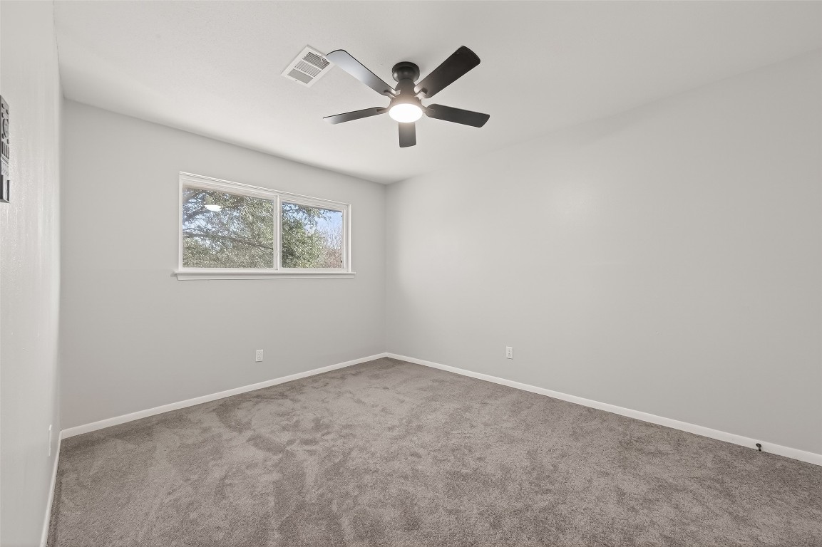 21710 Rotherham Drive Spring, TX 77388 - Photo 38 of 49 Upstairs third bedroom with ceiling fan, neutral tones, and comfortable carpet.