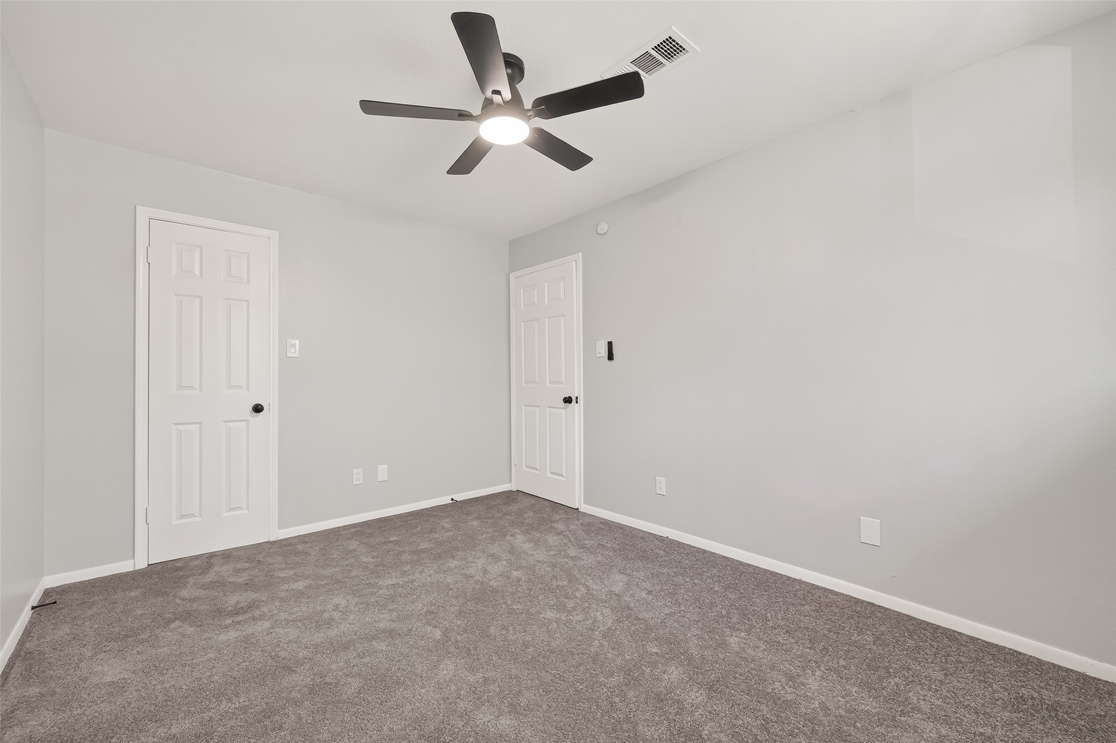 21710 Rotherham Drive Spring, TX 77388 - Photo 39 of 49 an empty room with a ceiling fan and a ceiling fan