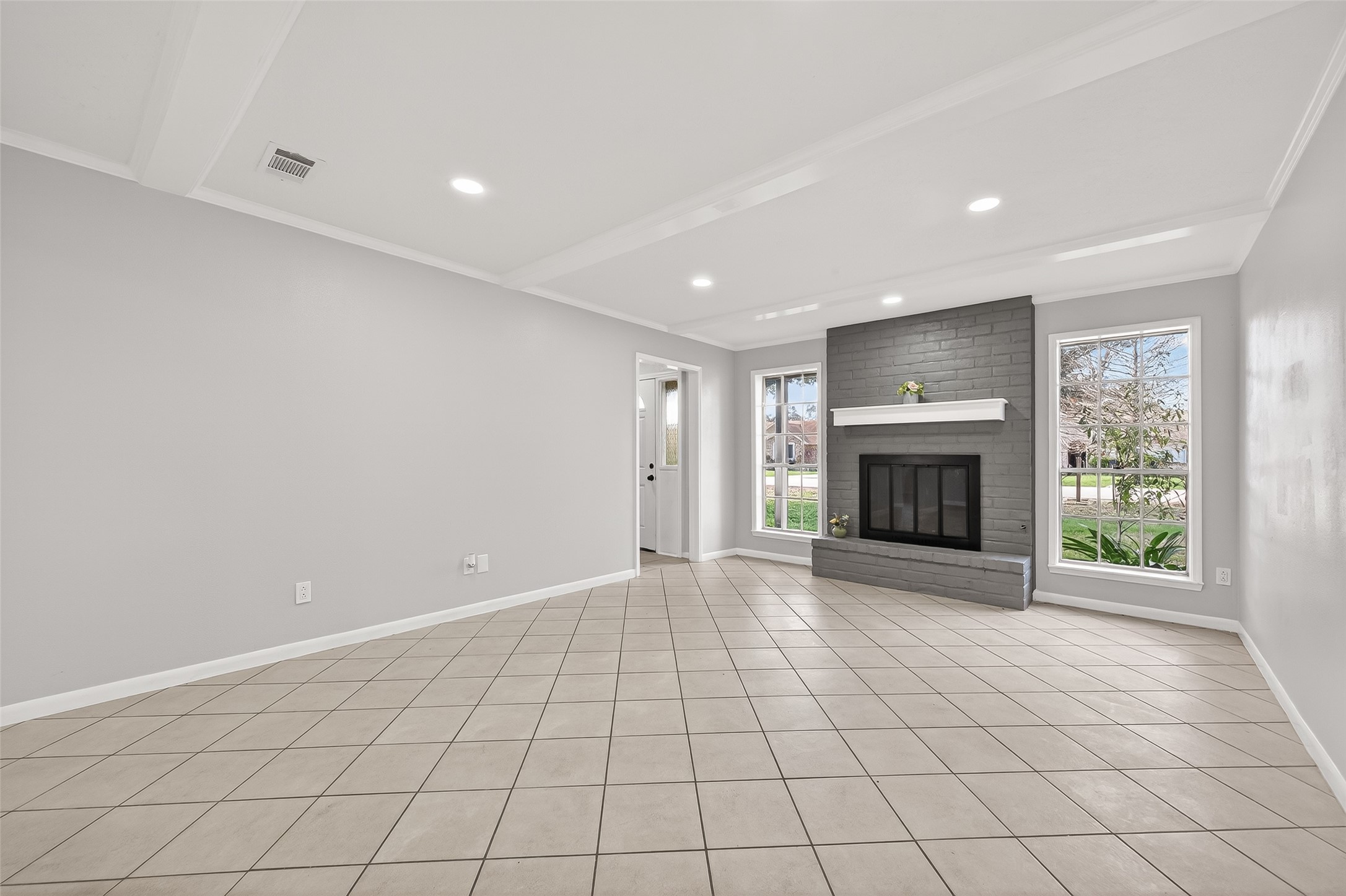 21710 Rotherham Drive Spring, TX 77388 - Photo 5 of 49 an empty room with fireplace and windows
