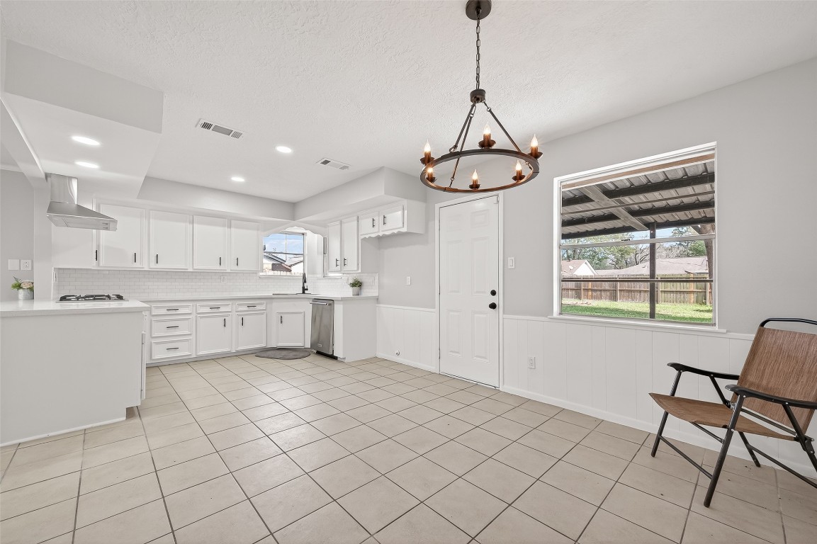 21710 Rotherham Drive Spring, TX 77388 - Photo 9 of 49 Dining area with chandelier and open connection to the kitchen.