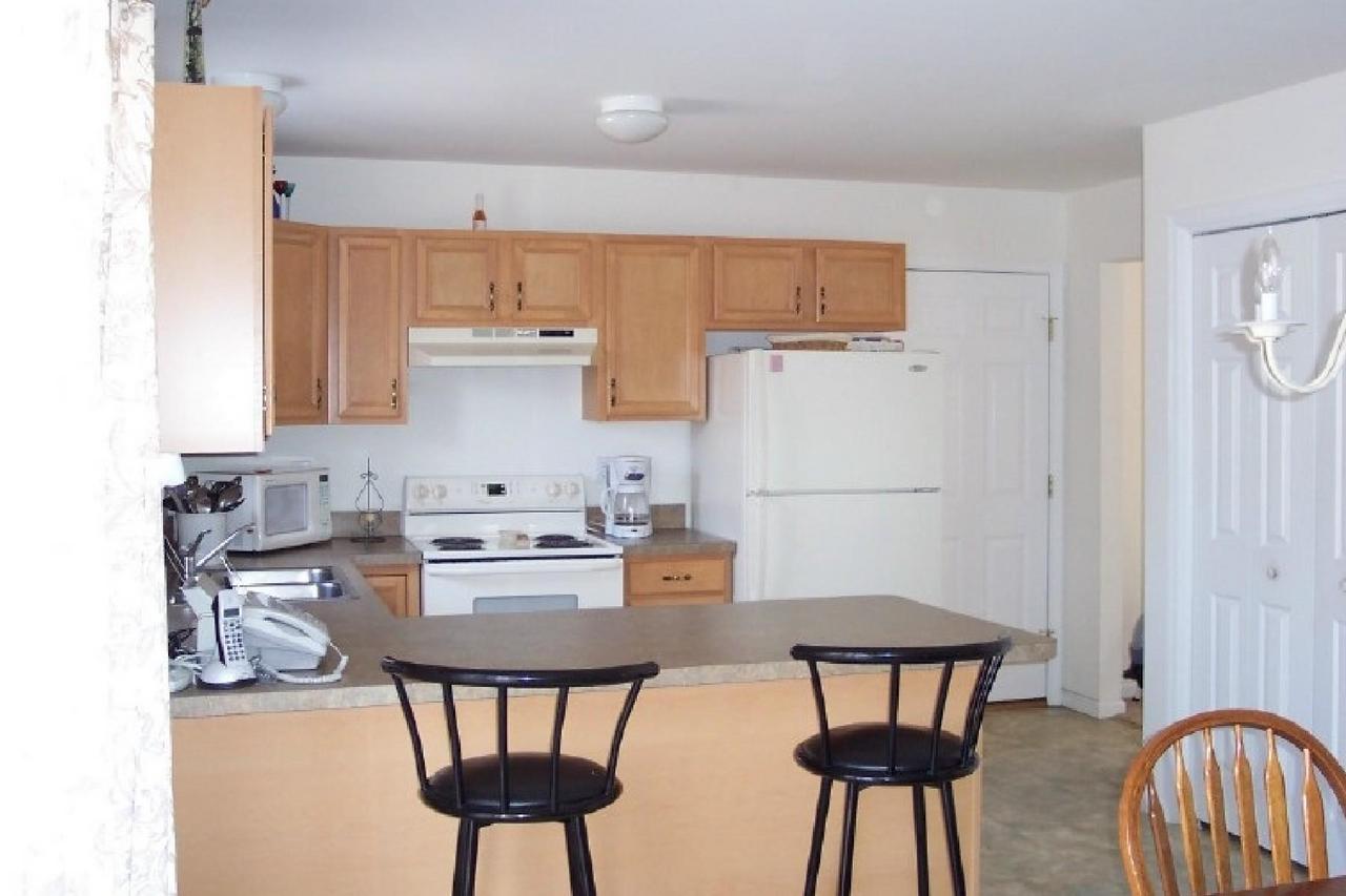 83 Snowflake Court Bushkill, PA 18324 - Photo 5 of 6 a kitchen with stainless steel appliances a dining table chairs and a refrigerator