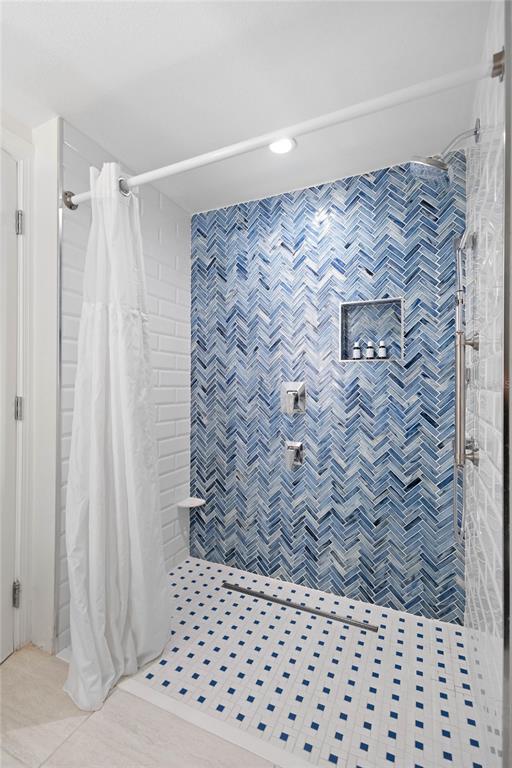 240 Sands Point Road, Unit 4104 Longboat Key, FL 34228 - Photo 21 of 47 a bathroom with a shower curtain